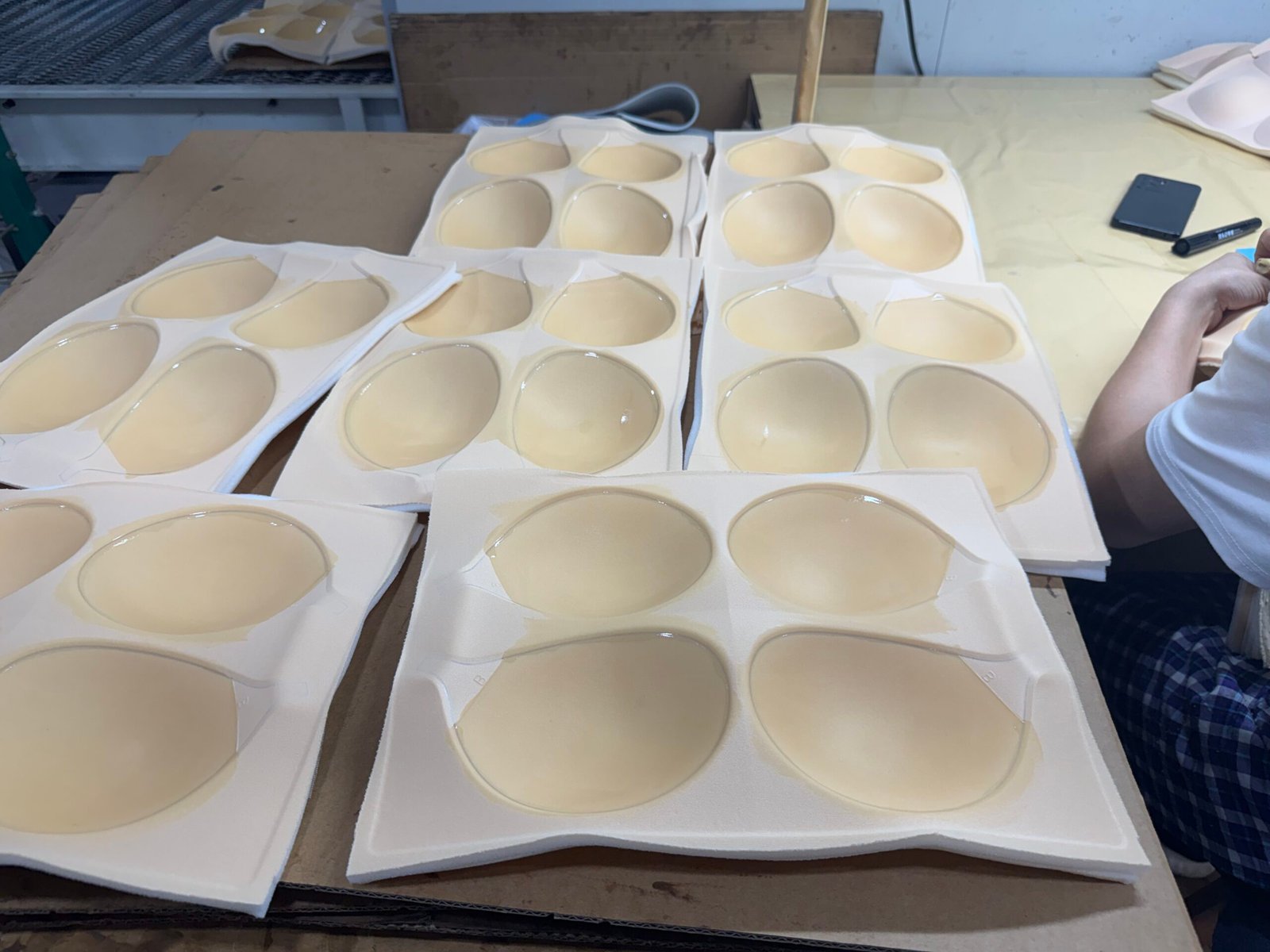 Manual brushing of silicone adhesive for adhesive bra production
