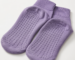 Purple anti-slip socks with raised silicone grip dots on the sole