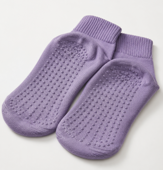 Purple anti-slip socks with raised silicone grip dots on the sole