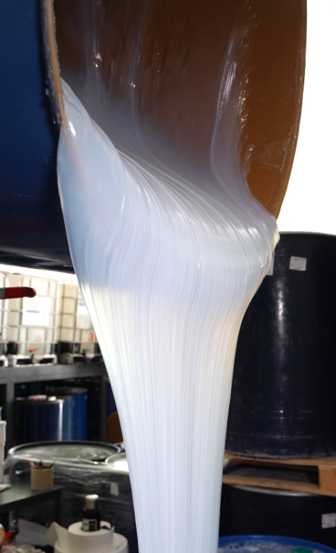 White liquid silicone flowing before curing