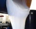 White liquid silicone flowing before curing