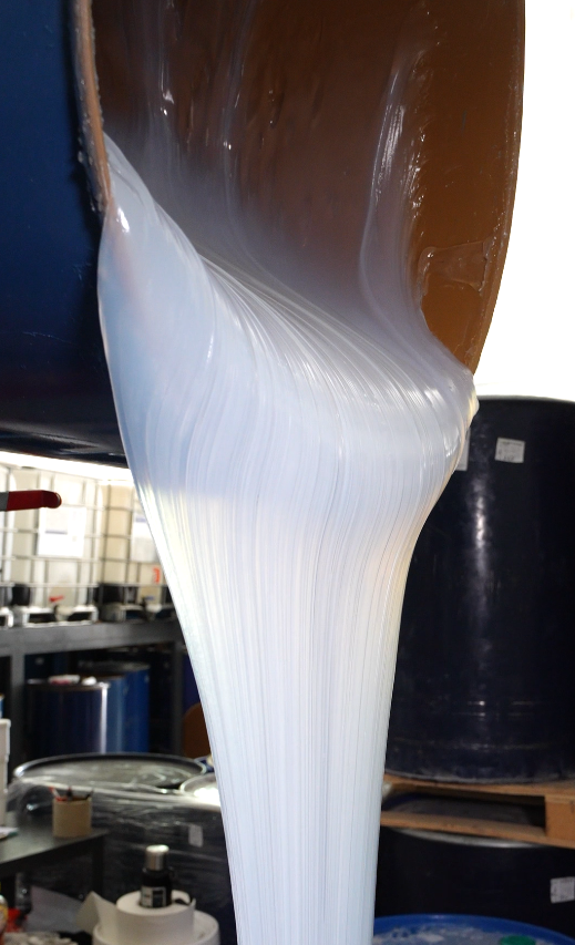 White liquid silicone flowing before curing