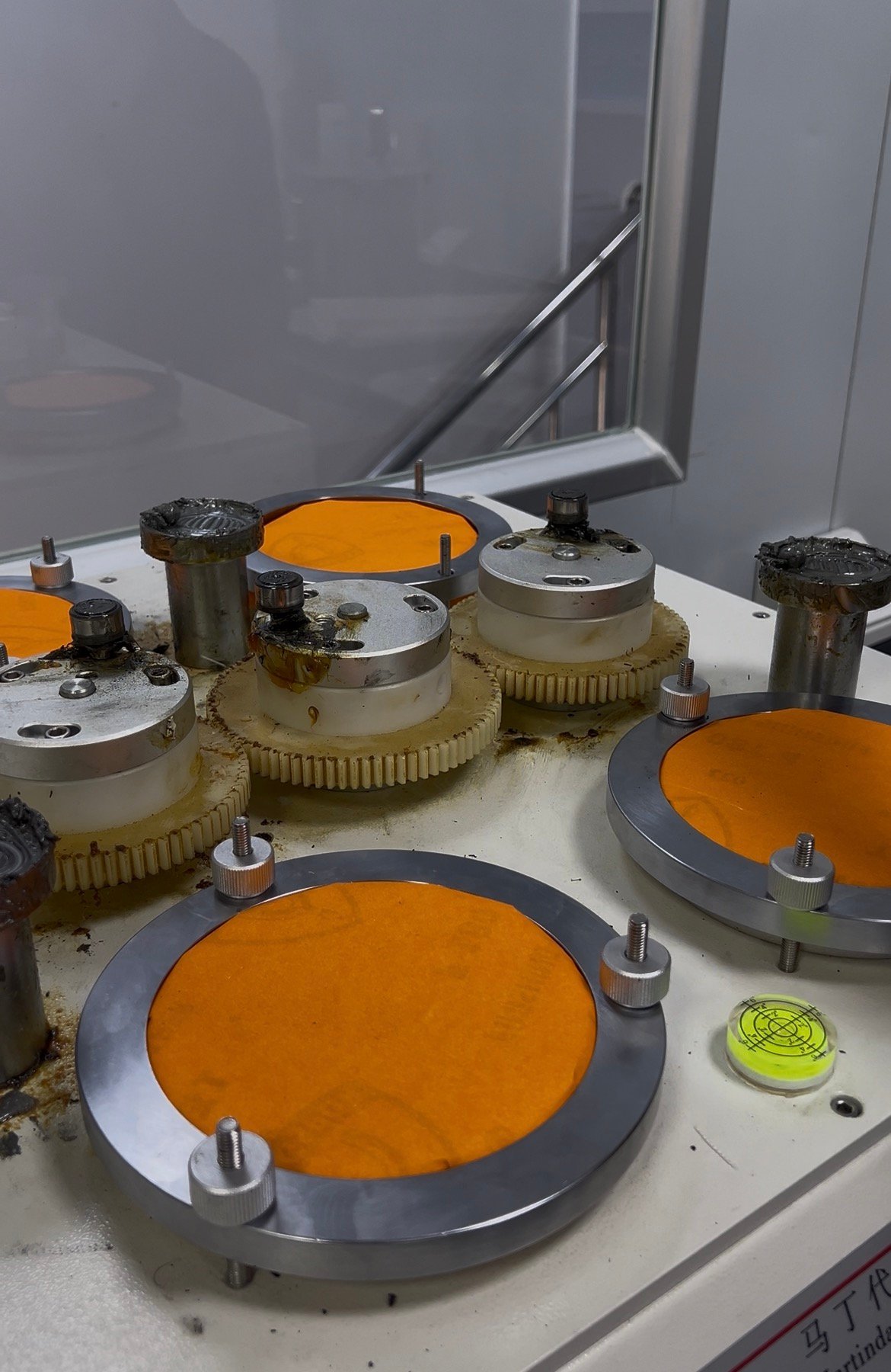 Martindale abrasion tester with abrasive paper for wear resistance testing